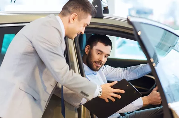 man is buying a car