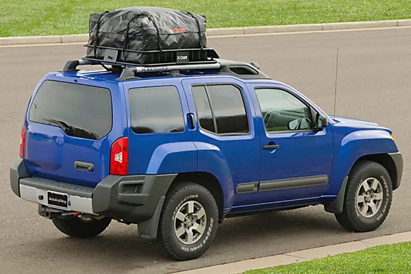 A car with luggage on its roof rack