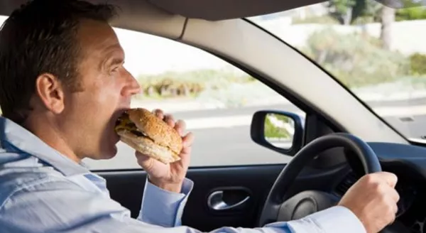 a girl eating while driving