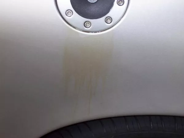 When gas tank overflows, the gasoline will evaporate then leave the stains. gas tank overflows