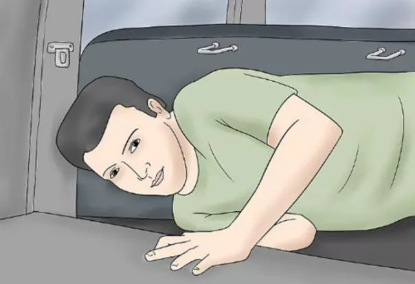 Crawl inside the car and unlock the back passenger door a man crawling inside the car through trunk