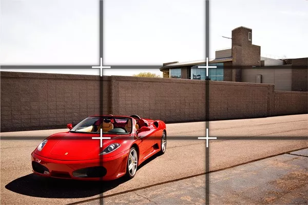 A red car seen through camera lens