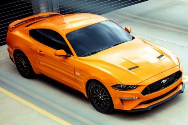 A picture of an orange Ford Mustang GT.