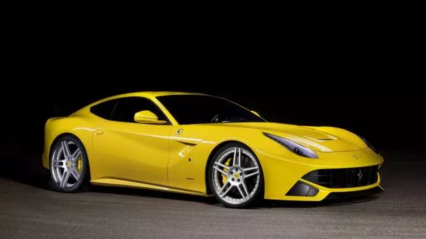 a yellow car in front of a black background