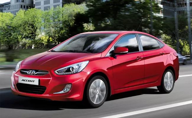 A red Hyundai Accent sedan angular front view