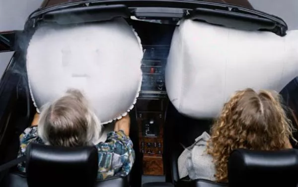 Children with airbags in a car