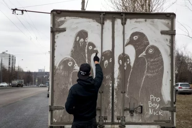 drawing on the dusty tailgates of a truck