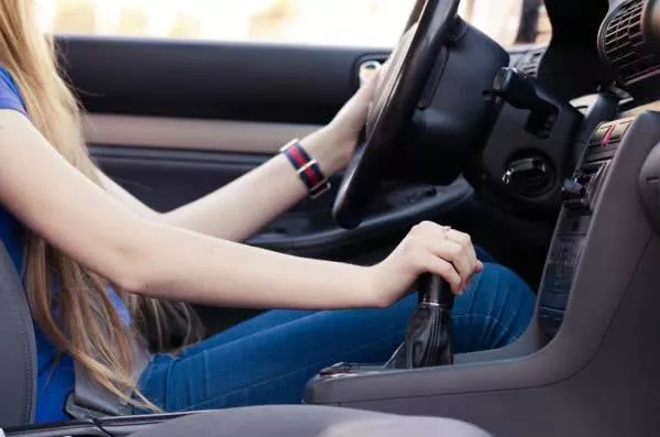 a female riding the car shifter