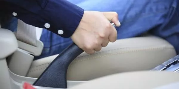 a male holding car handbrake