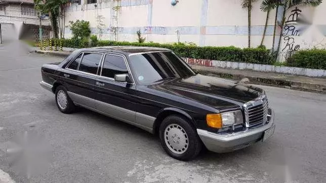 A black Mercedes-Benz S-Class on the road