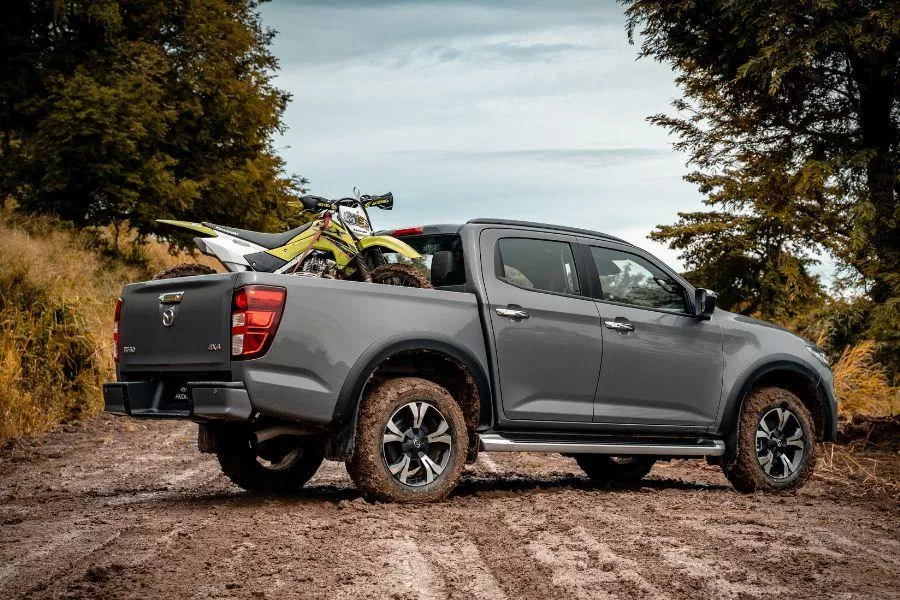 A shot of the rear of the BT-50 while parked in the middle of an unpaved road