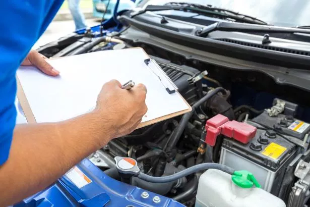 a mechanic checking a car