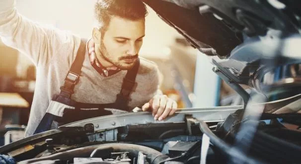 A man checking engine oil