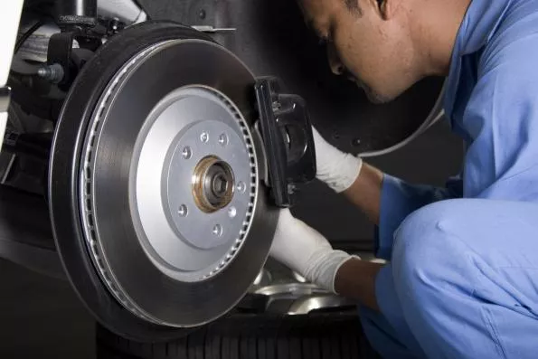 a mechanic checking car brakes