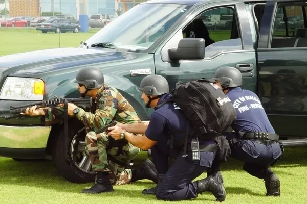 Hiding behind a car to avoid being shot