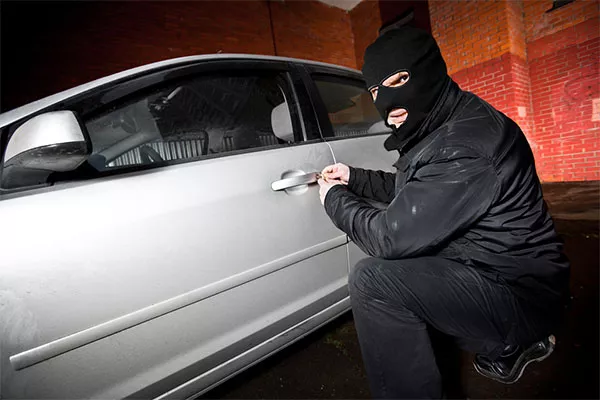 A robber is stealing a car