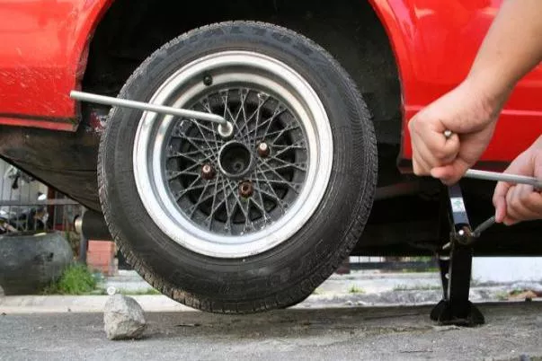 Pump the jack until you can lift the tire far enough off the ground Lift the tire