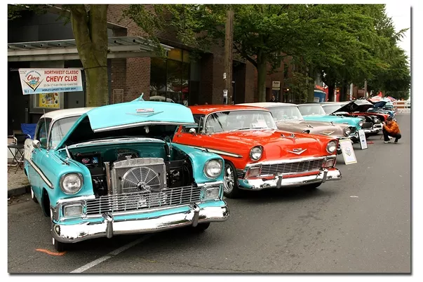 Some classic vehicles parked on the road