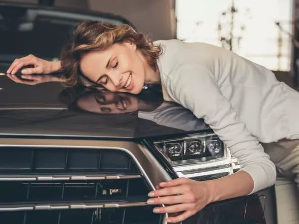 A woman holding a car