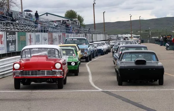 parade of classic cars on the road