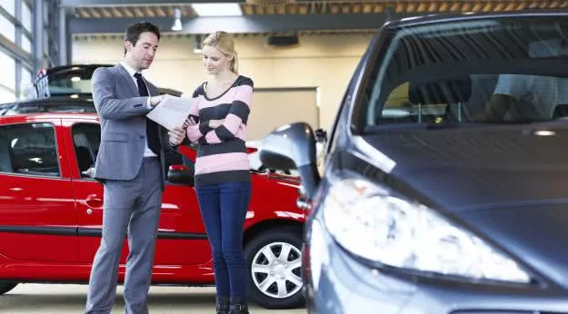 a car saleman talking to his customer