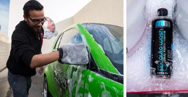 a man washing a green car