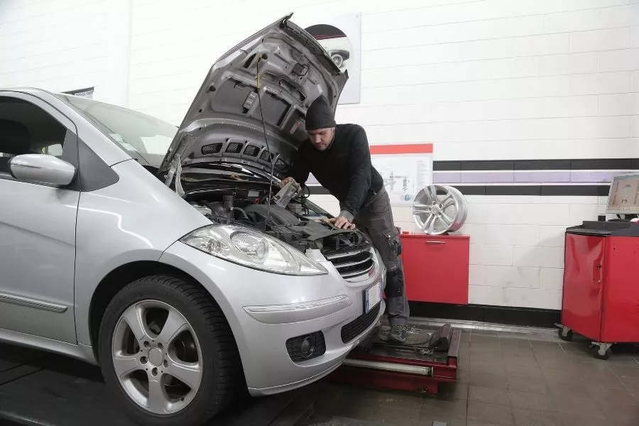 Car mechanic fixing an engine