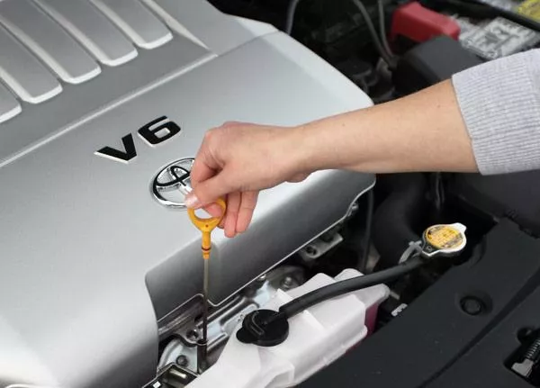 a man checking engine oil