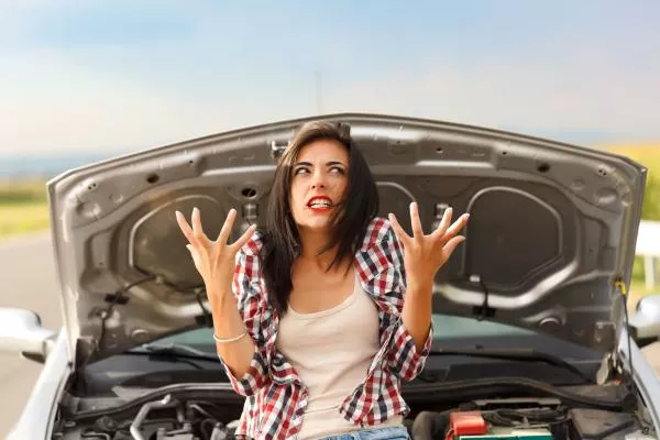 A girl in front of an engine bay