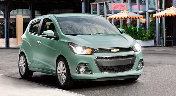 A green Chevrolet Spark on the road