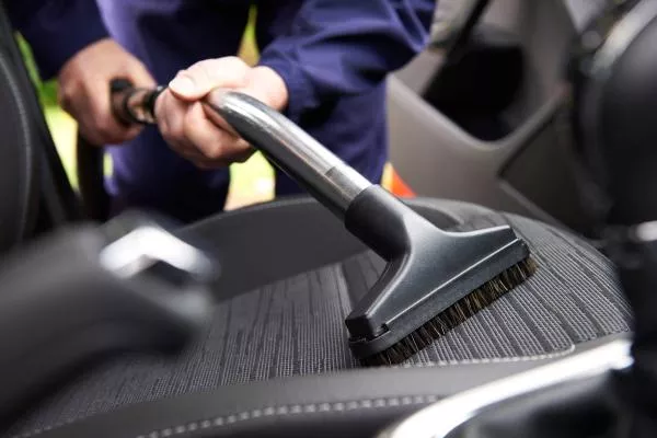 Cleaning a car interior with vacuum