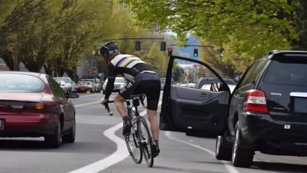 Car door opened to a cyclist