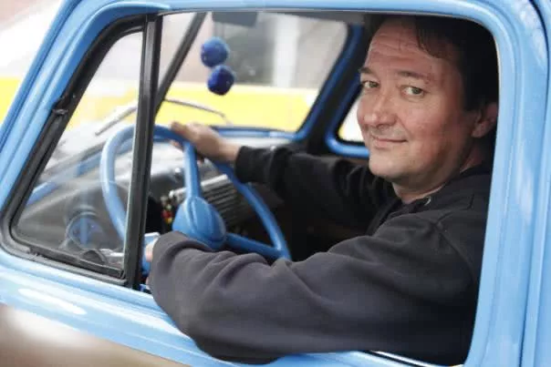 a man leaning his elbow in the car window