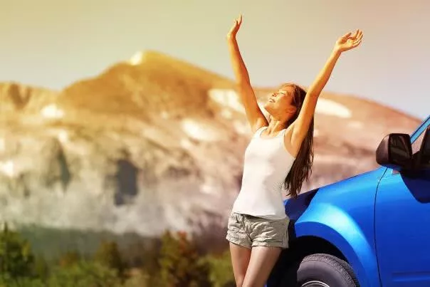 a woman stretching next to her car