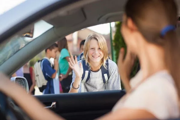 a mom drive off her kid to school