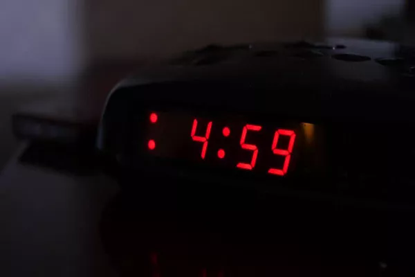 a clock showing 4.59 am