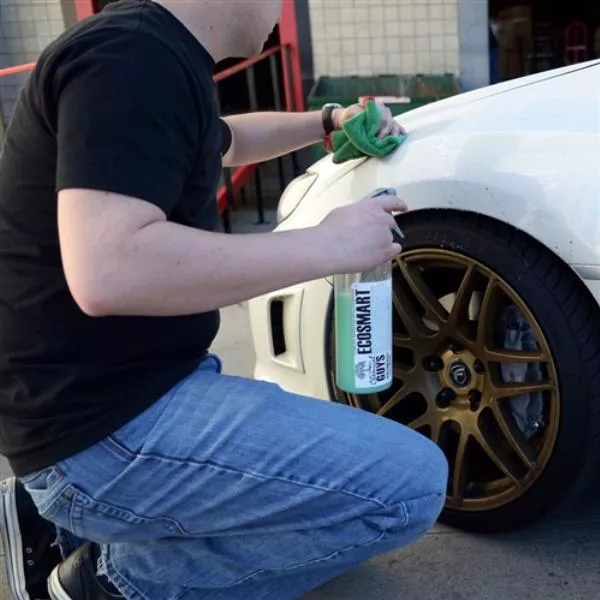 a men cleaning his car by EcoSmart-RU waterless wash & wax