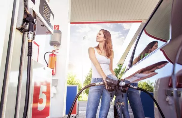 a girl filling fuel