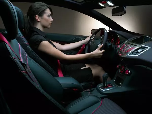 a girl sitting on driver seat in a car