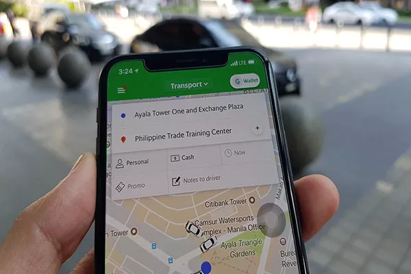 using grab taxi app on smartphone