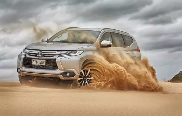 A Mitsubishi running on sand 