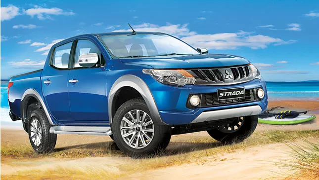A blue Mitsubishi Strada on beach