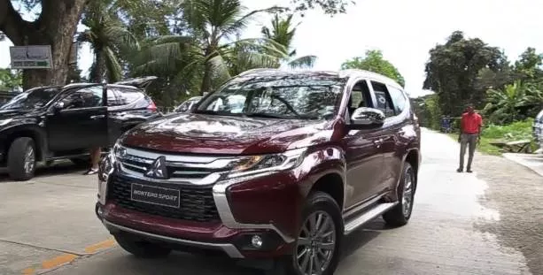 A red mitsubishi montero sport on the road