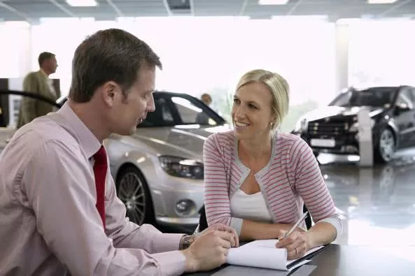 A car salesman listening to his customer