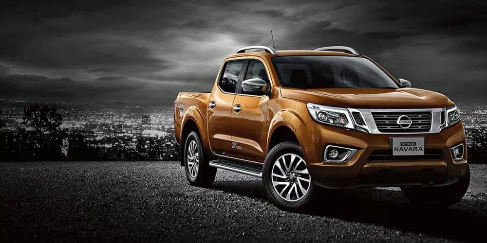 An orange Nissan Navara on the road