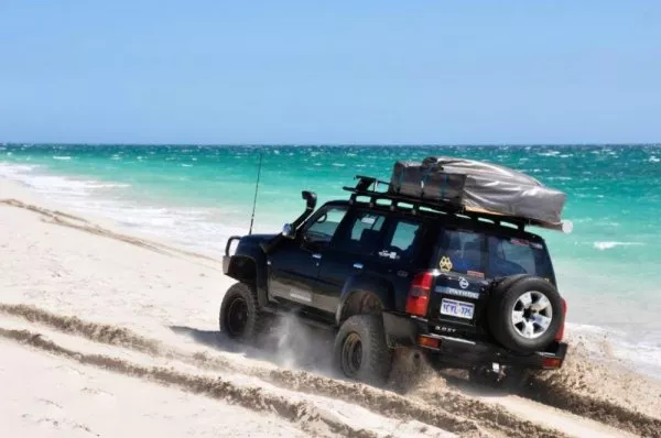 Keep your momentum up and stop only when you feel safe. SUV on the beach
