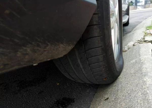 Parking car on the sidewalk and partly on the street