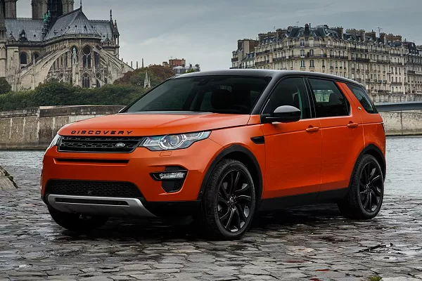 angular front of an orange Land Rover Discovery 