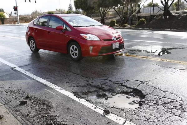 a car driving near a pothole