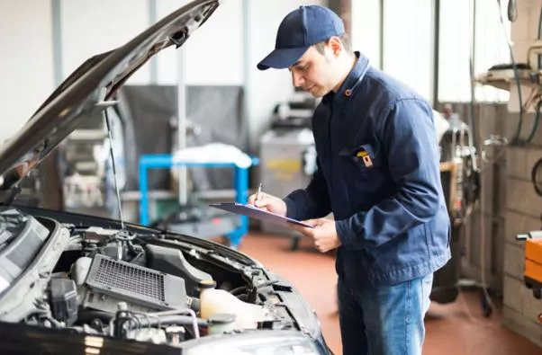 A mechanic is checking the car engine